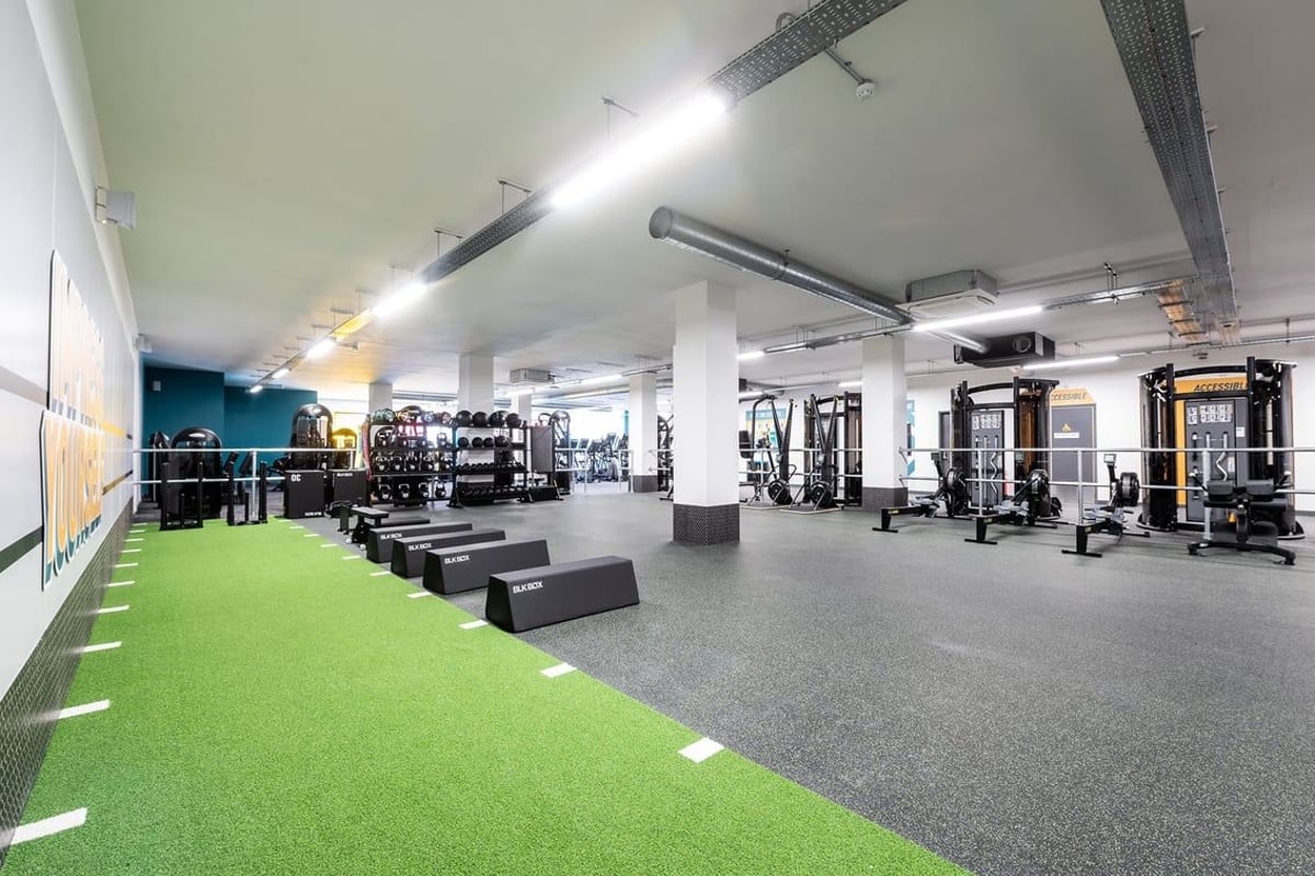 PureGym London Catford Rushey Green: Gym with weight machines, free weights, turf area, and rubberized flooring.