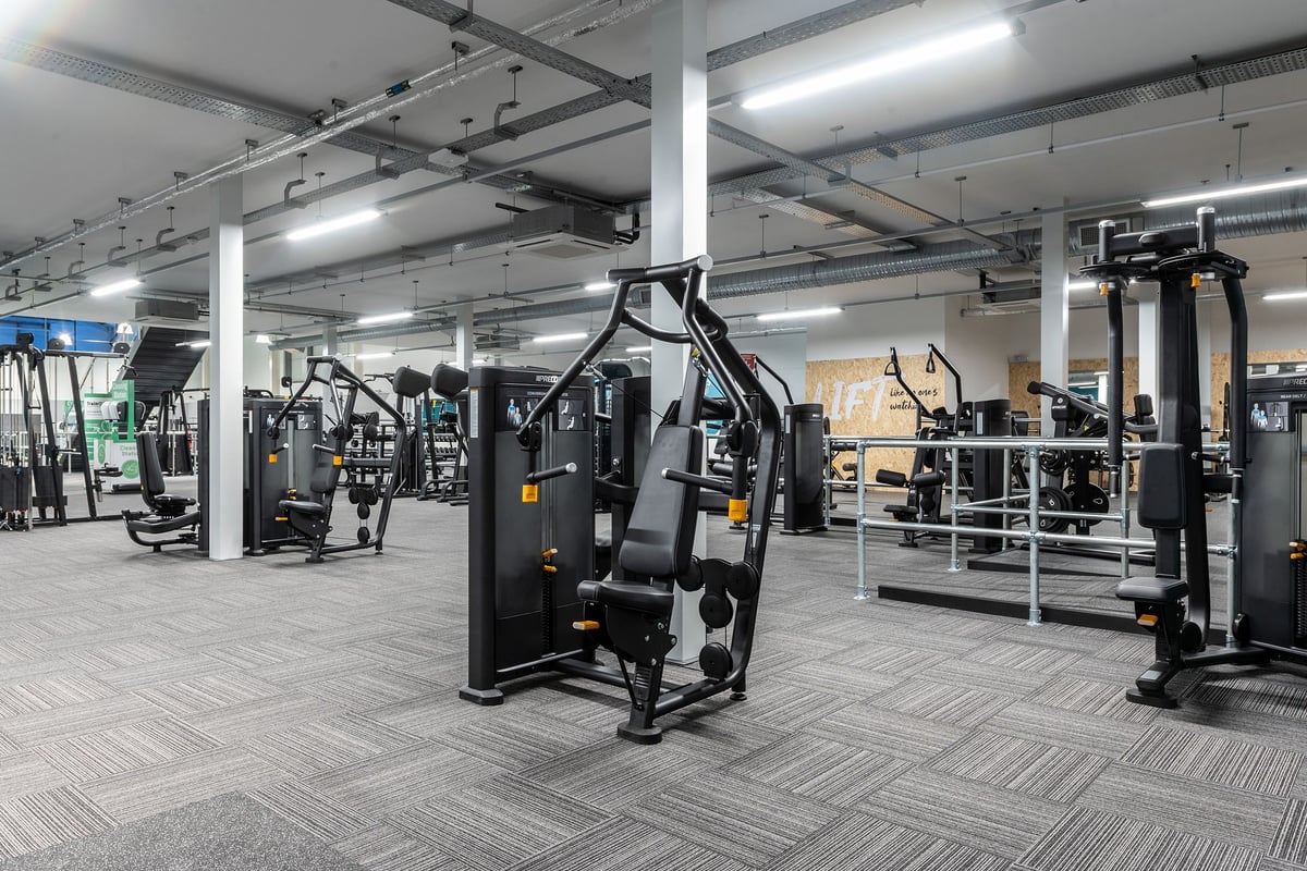 PureGym Torquay Bridge Retail Park: Strength machines, free weights, benches, and rubberized flooring in a well-equipped gym.