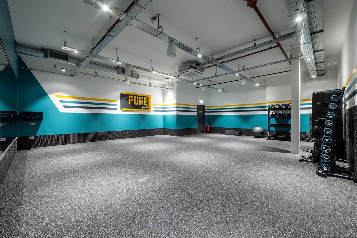 PureGym Erith: Rubberised flooring in a teal and grey fitness studio.