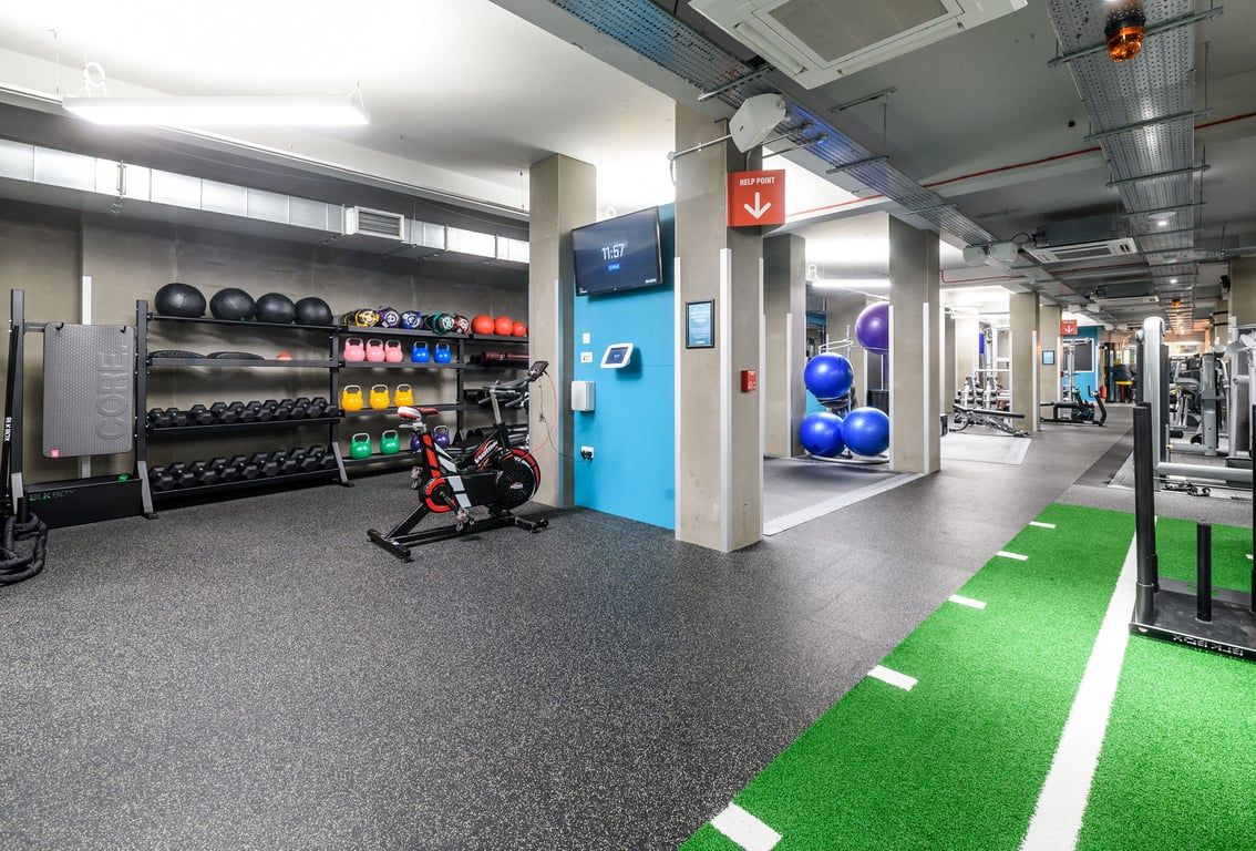 PureGym London Lewisham: Free weight racks, medicine balls, turf area, resistance machines, rubberized flooring.
