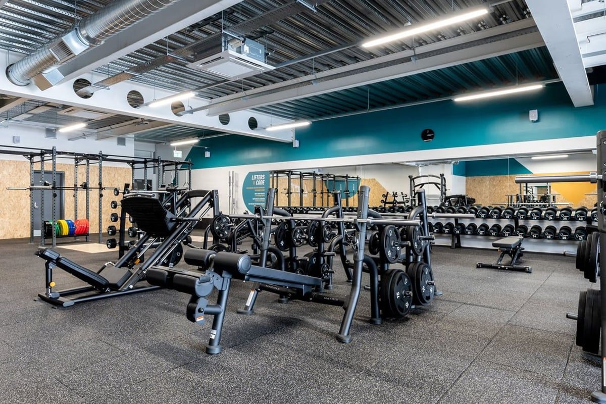 PureGym Yate: Rows of weight benches, racks, dumbbells, and resistance machines in a modern gym interior.
