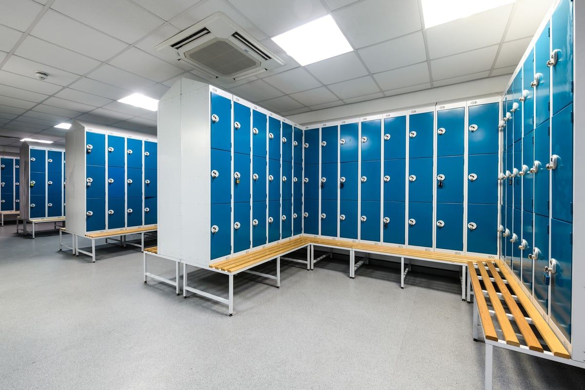 PureGym Bournemouth The Triangle: Rows of blue lockers, benches, and an accessible ramp in a changing room.