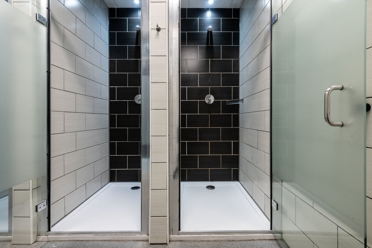 PureGym Aberdeen Kittybrewster: Shower stalls with tiled walls, floors, and entrances.