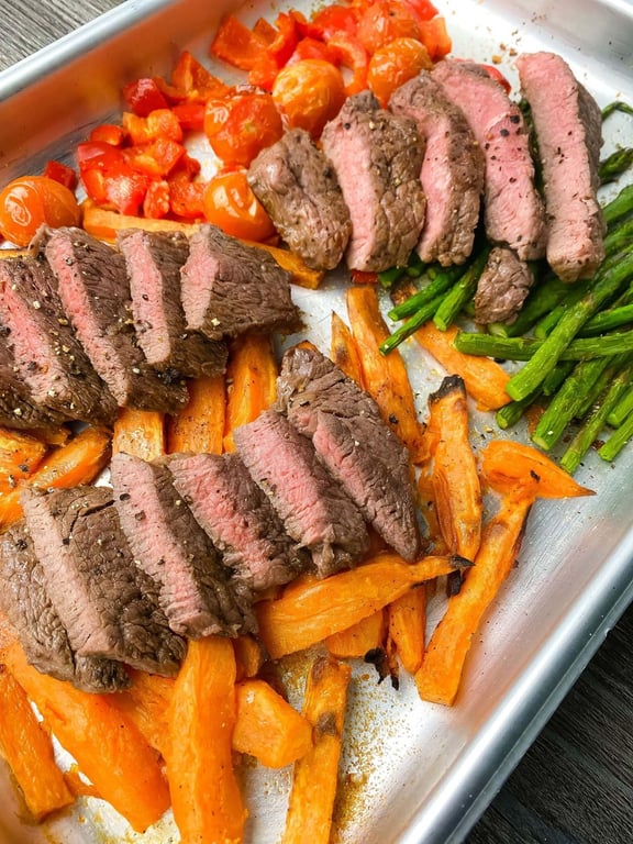 Sliced steak on a bed of vegetables