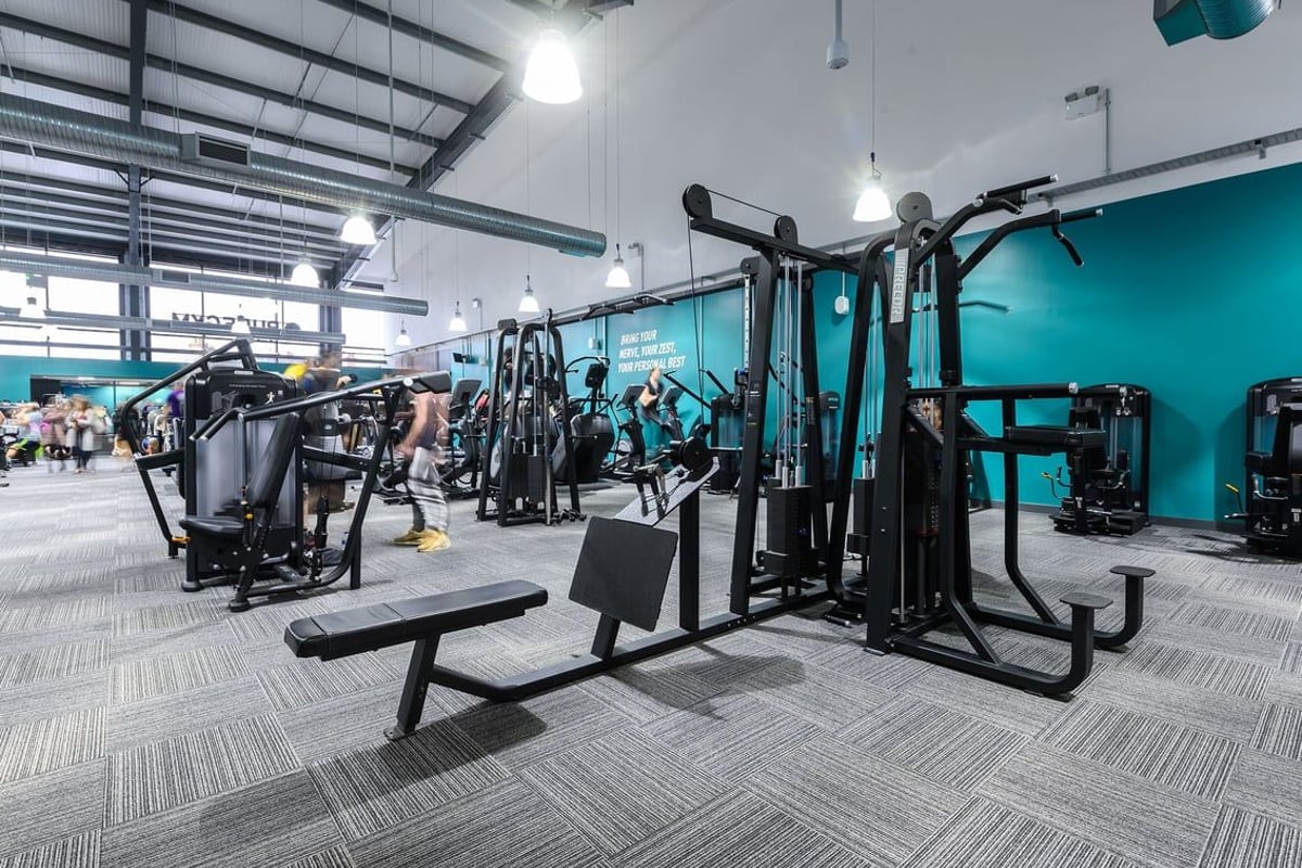 PureGym Bromsgrove Retail Park: Resistance machines, free weights, benches, and rubberized flooring in a gym facility.