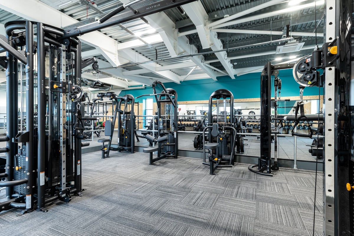 PureGym Bicester: Resistance machines, squat racks, weight stacks, rubberized flooring in well-equipped gym.