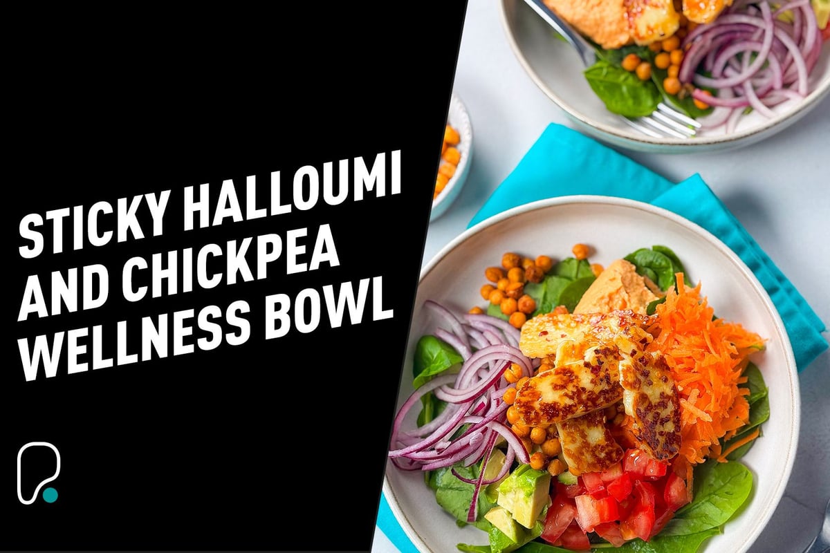 Bowls of halloumi, chickpeas, spinach, grated carrot, tomato, avocado