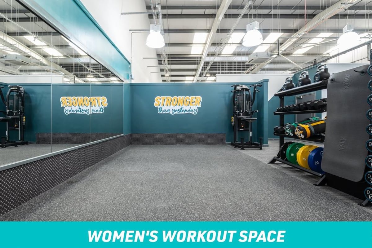PureGym Paisley Women's Workout Space: large mirror, mats, kettlebells, dumbbells, sandbags, weight plates, assisted pull up machine