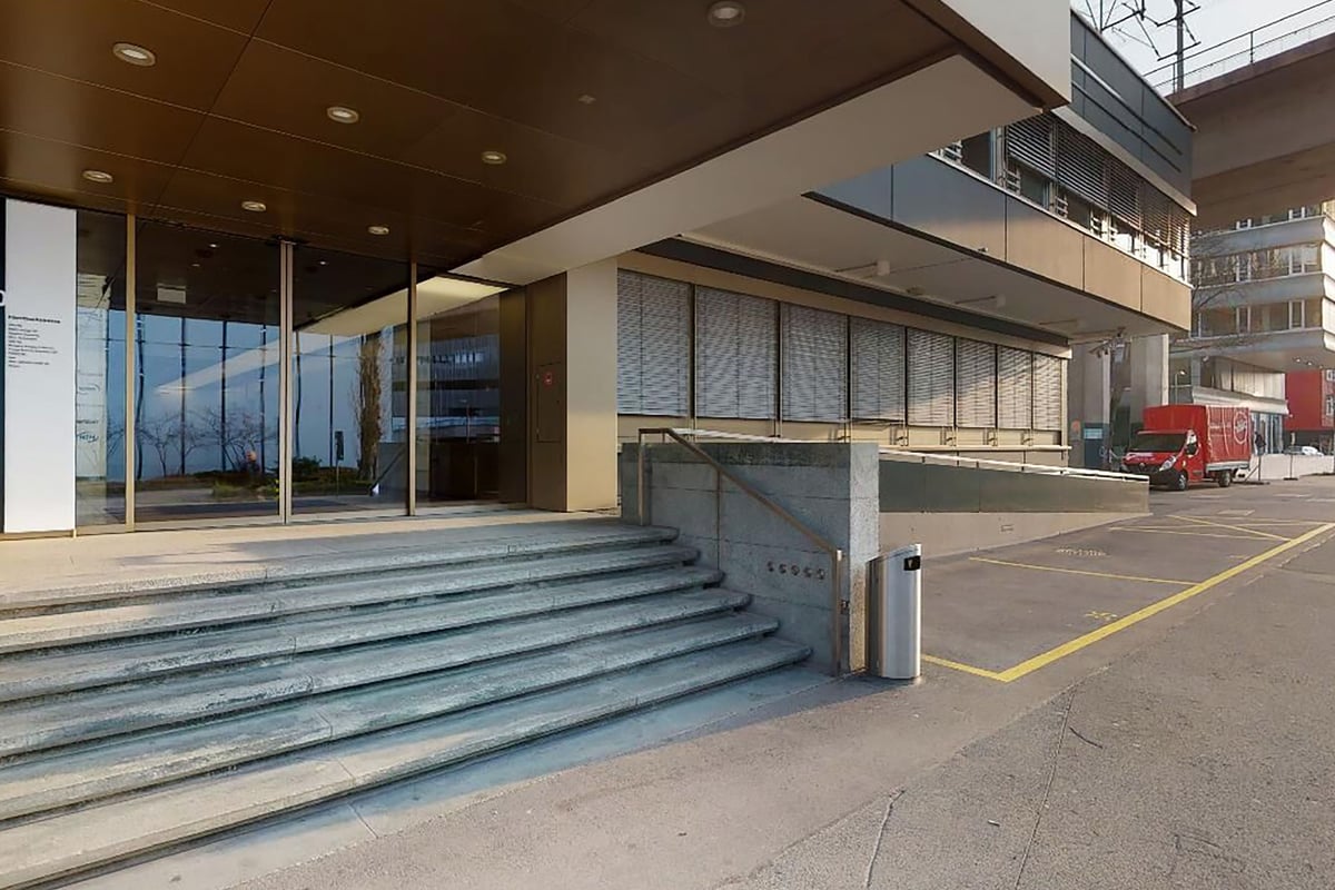 PureGym Zürich West: Ein modernes Gebäude mit Glasfassade, Stufen und dem Eingang zum PureGym.