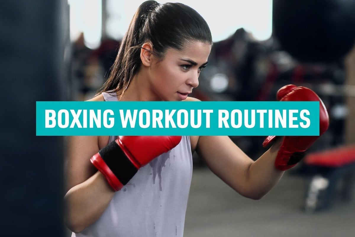 Woman in red boxing gloves training with punching bag in gym