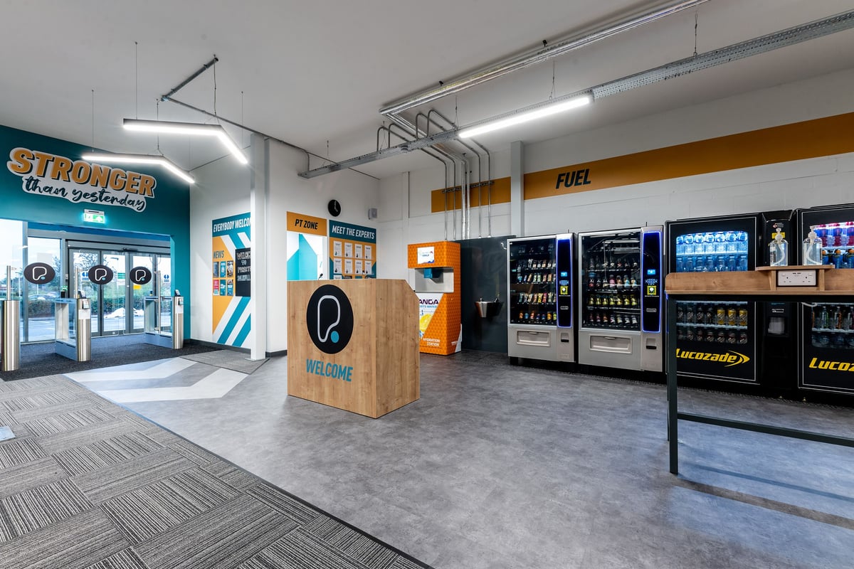 PureGym Solihull Sears Retail Park: Vending machines, yanga water, and welcome podium near the gym entrance.