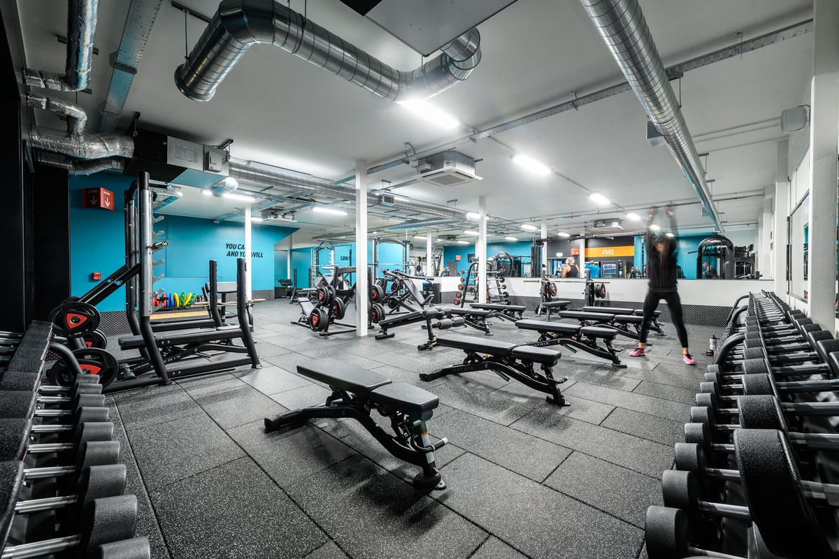 PureGym Swindon Mannington Retail Park: Gym interior with weight machines, benches, free weights, and teal accent walls.
