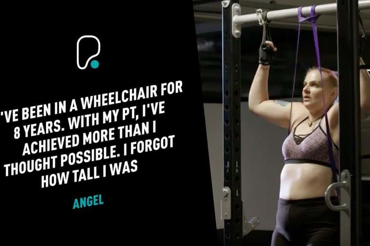 Woman in sportswear using resistance bands on gym equipment for pull-ups.