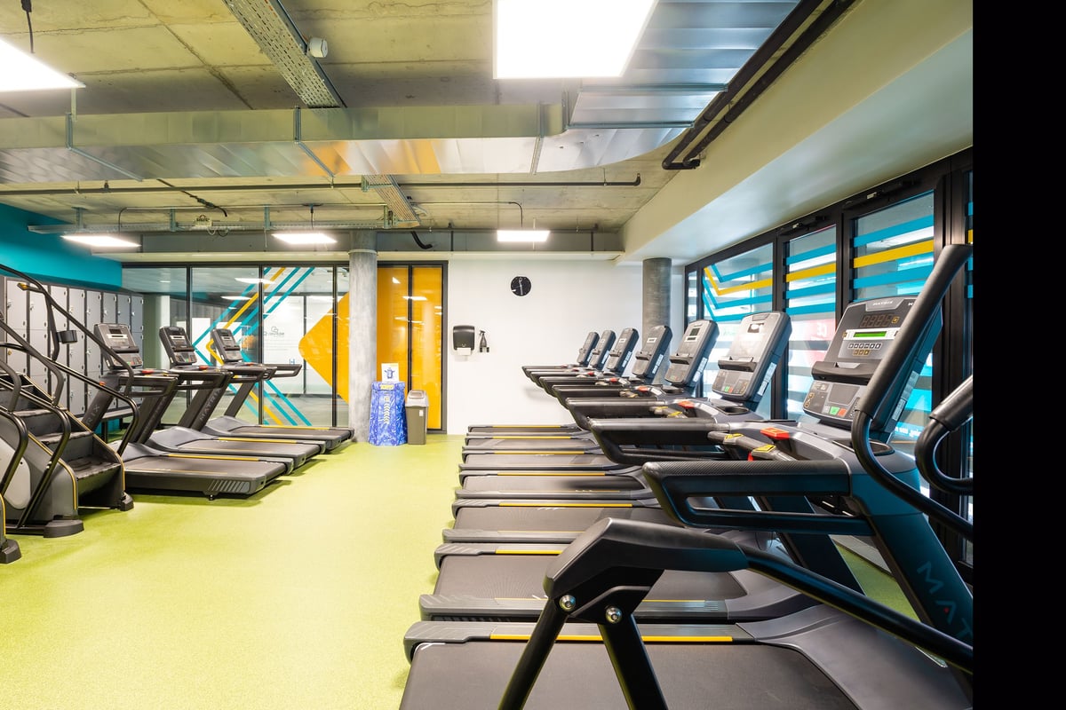 PureGym Genf Le Bouchet: Rows of treadmills, ellipticals, and exercise bikes.