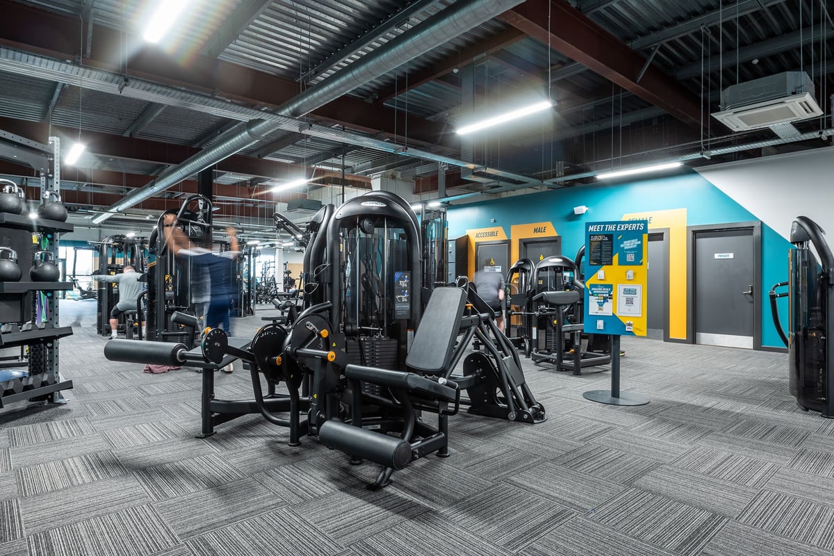 PureGym Craigavon: Weight machines, resistance equipment, benches, and rubberised flooring in a well-lit gym facility.