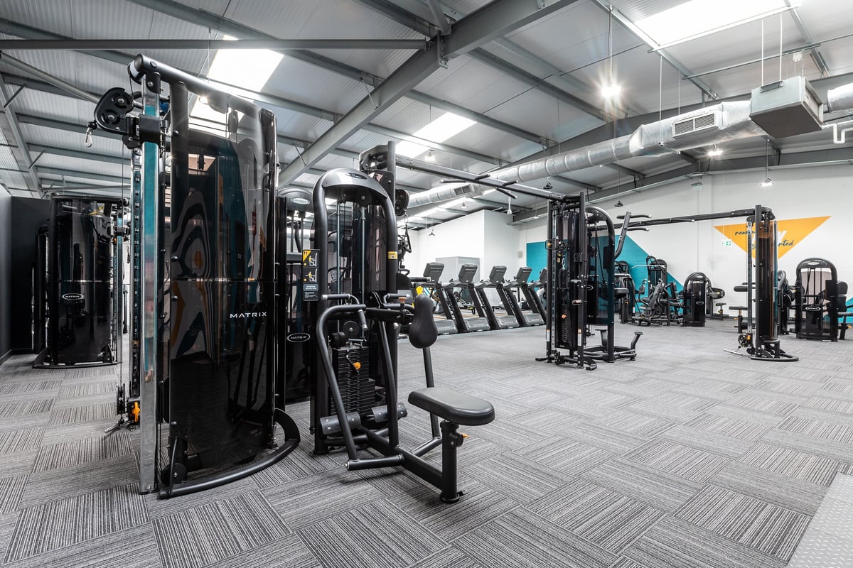 PureGym Coventry Warwickshire Shopping Park: Rows of resistance machines, weight benches, and rubberized flooring.