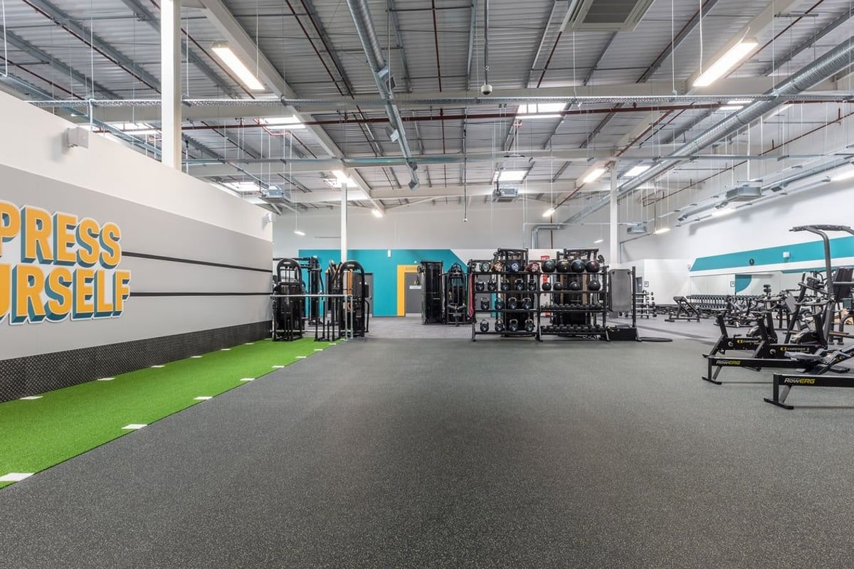 PureGym Nottingham Colwick: Exercise machines, free weights, turf area, "Press Yourself!" motivational wall signage.