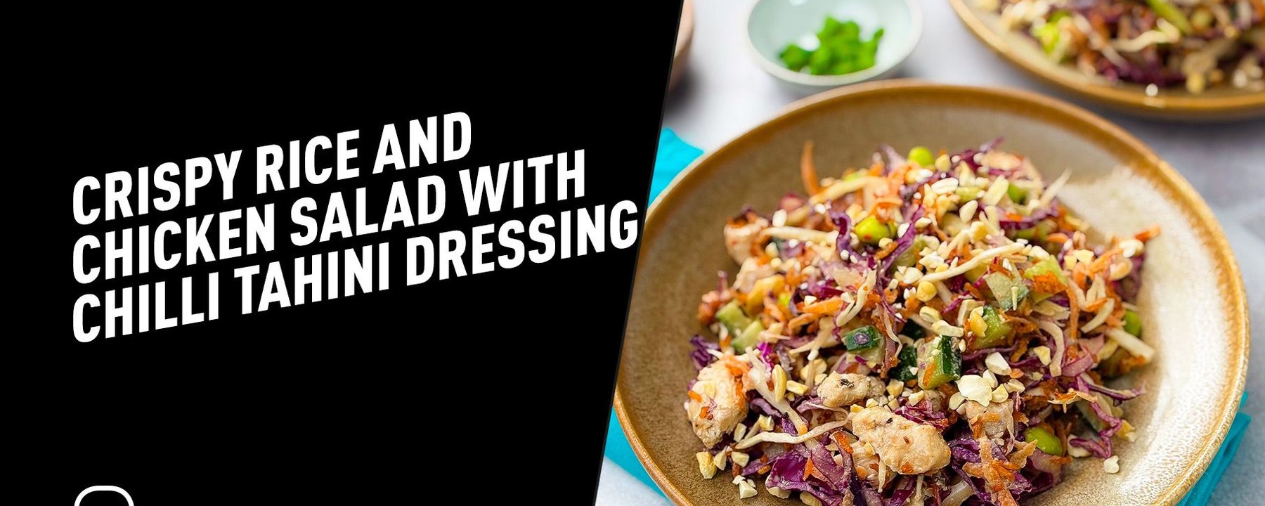 Two plates of colourful crispy rice and chicken salad with chopped vegetables and nuts