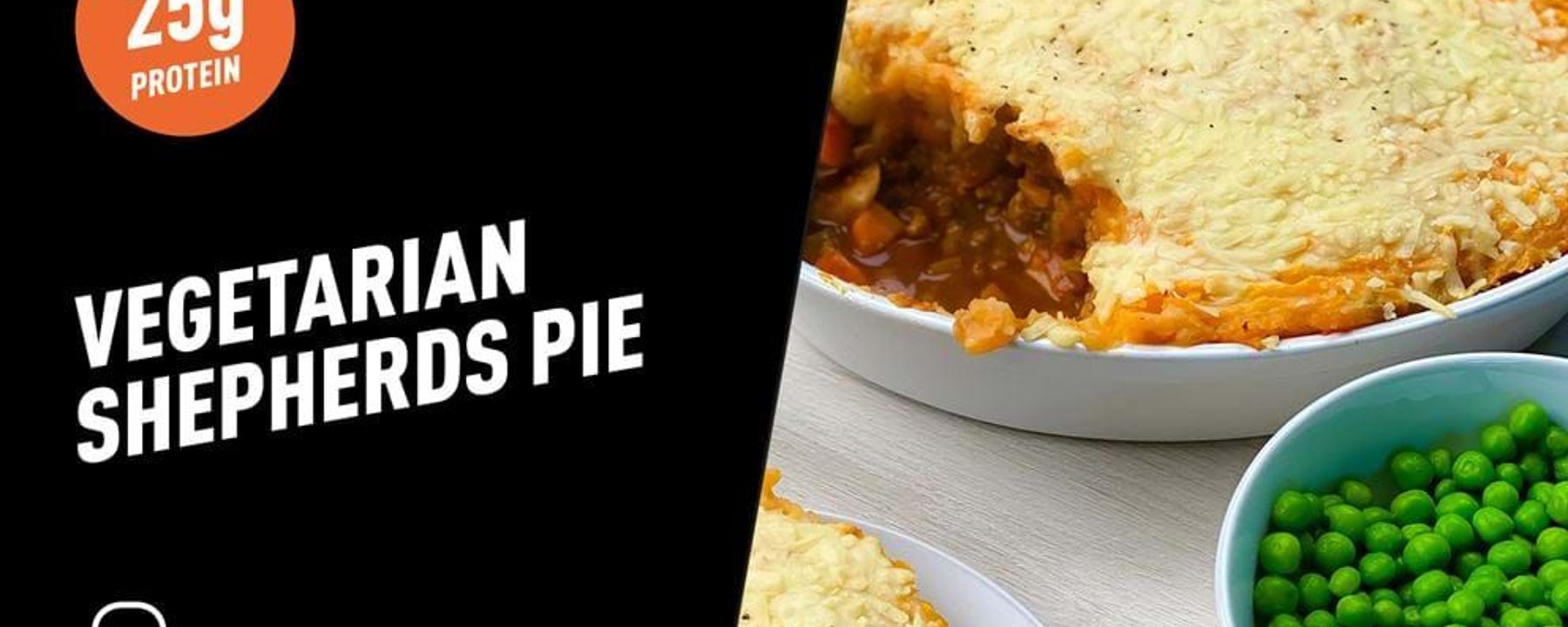 Vegetarian shepherds pie with melted cheese topping and a bowl of green peas.