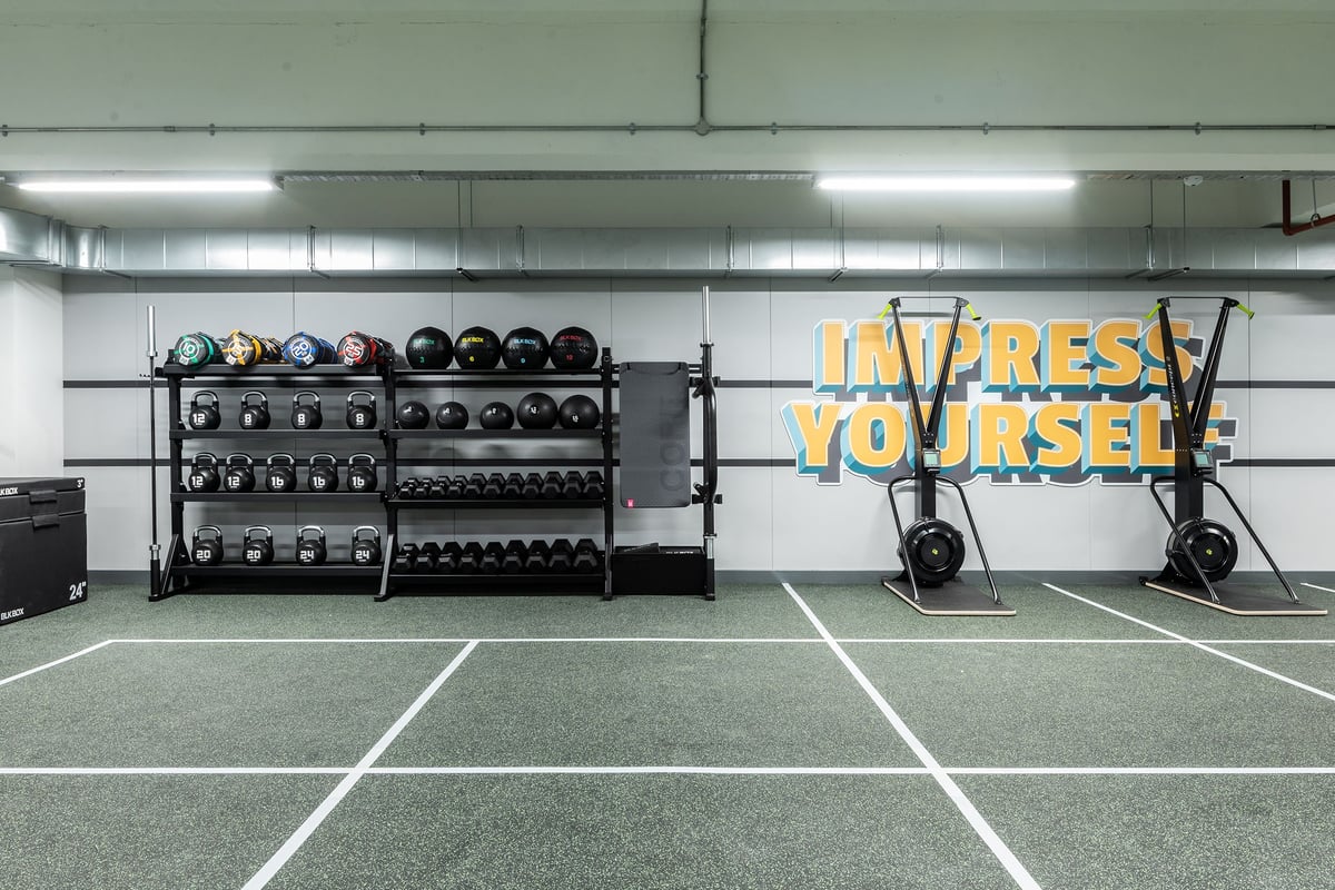 PureGym Gravesend: Weights racks, medicine balls, floor mats, and 'Express Yourself' signage in a gym setting.