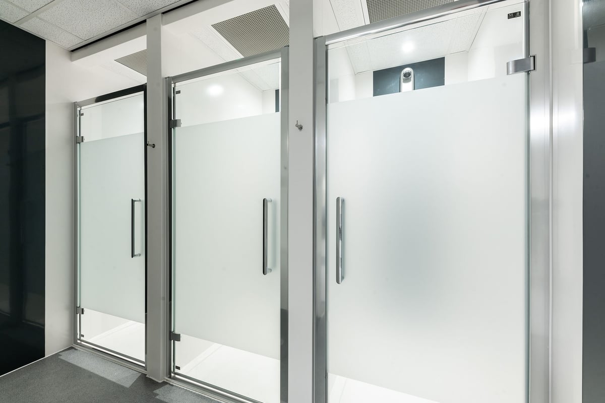 PureGym Bangor Wales: Glass doors with metal frames, reminiscent of gym entry or changing rooms.