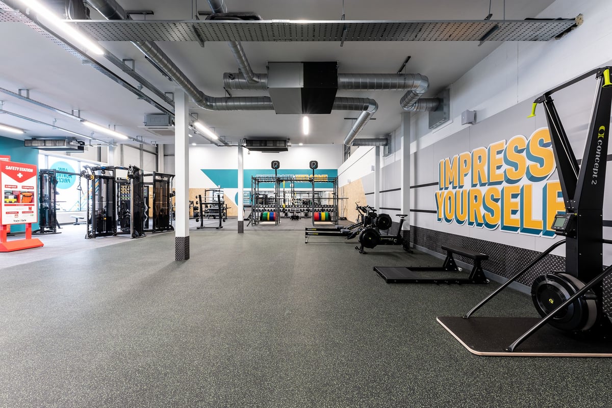 PureGym Galashiels: Squat racks, cable machines, weightlifting platforms, and emblazoned motivational signage.