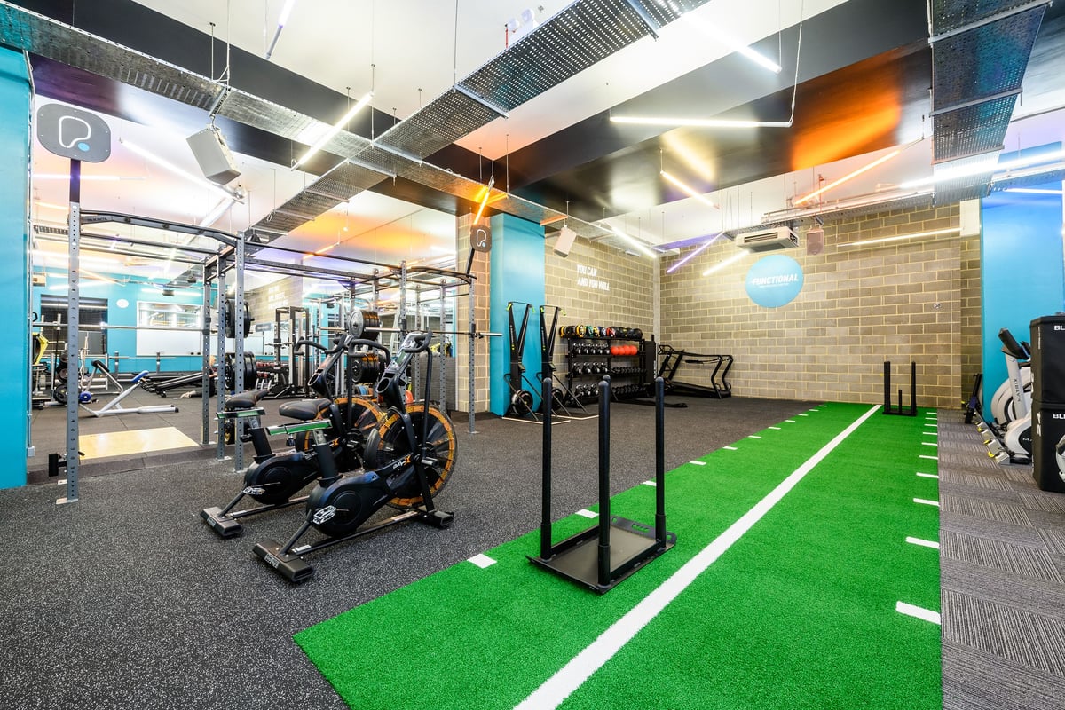 PureGym London Borough: Treadmills, weight racks, turf training area, resistance machines in modern fitness studio.