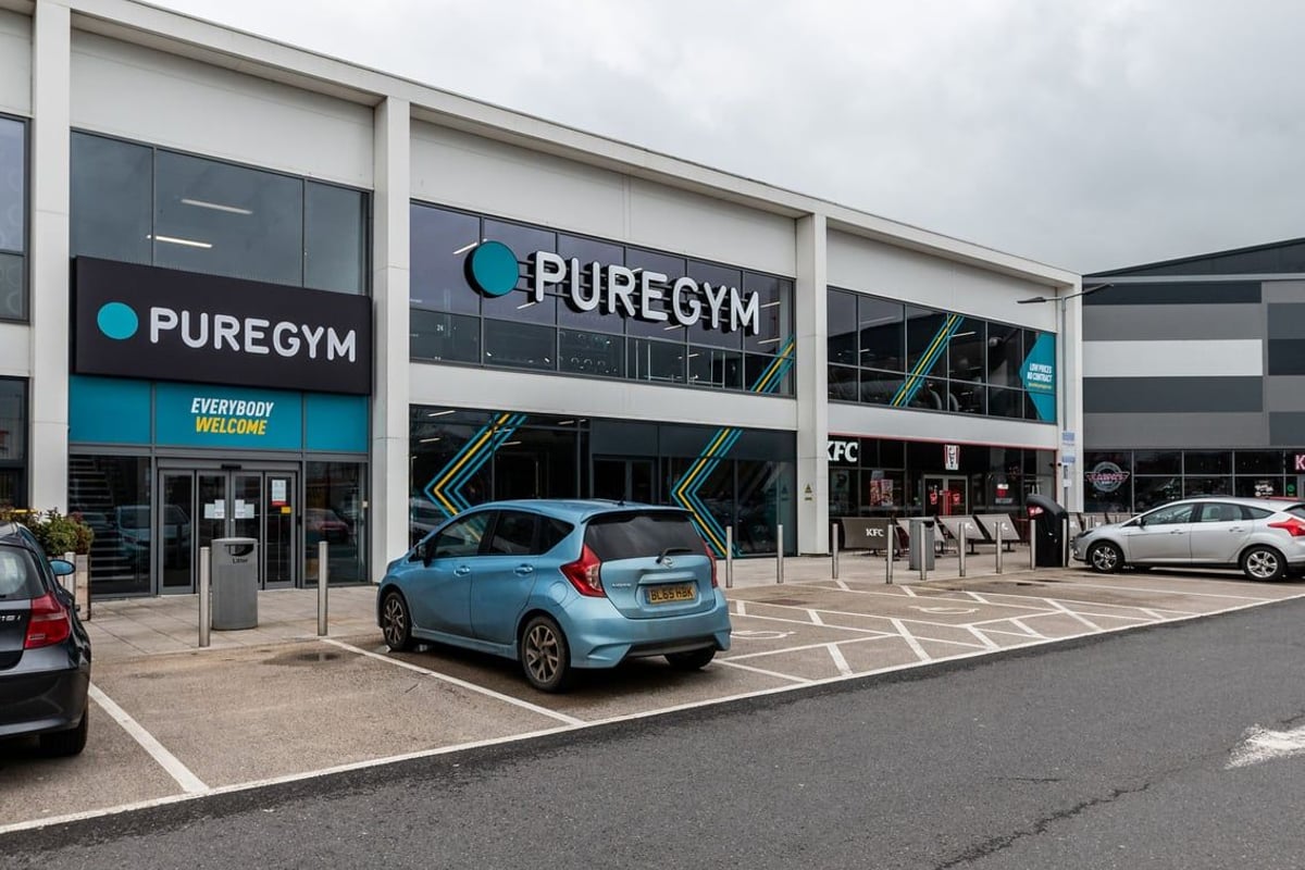 PureGym Yate: Building exterior with PureGym branding, parked cars, and pedestrian access.