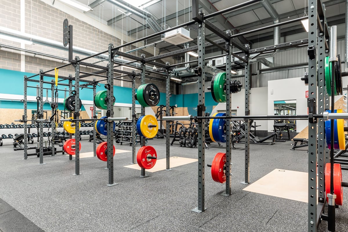 PureGym Sittingbourne: Squat racks, weight plates in multiple colours, weight benches, and rubberized flooring.