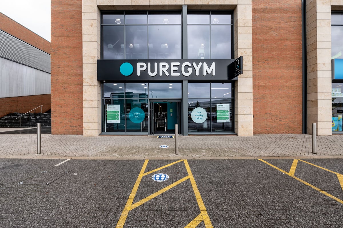 PureGym Birmingham Longbridge: Pure Gym entrance, parking spaces marked in yellow on asphalt surface.