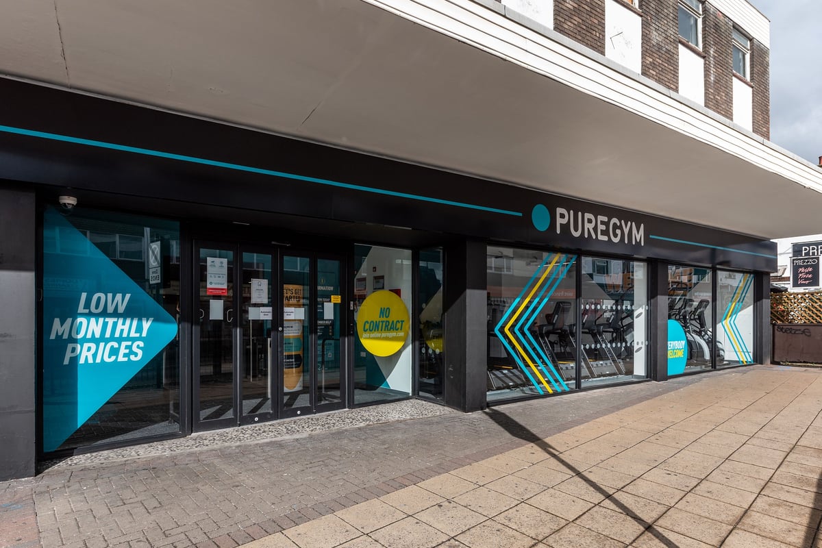 PureGym London Hornchurch: Gym storefront with teal branding, weights display, and 'Low Monthly Prices' signage.