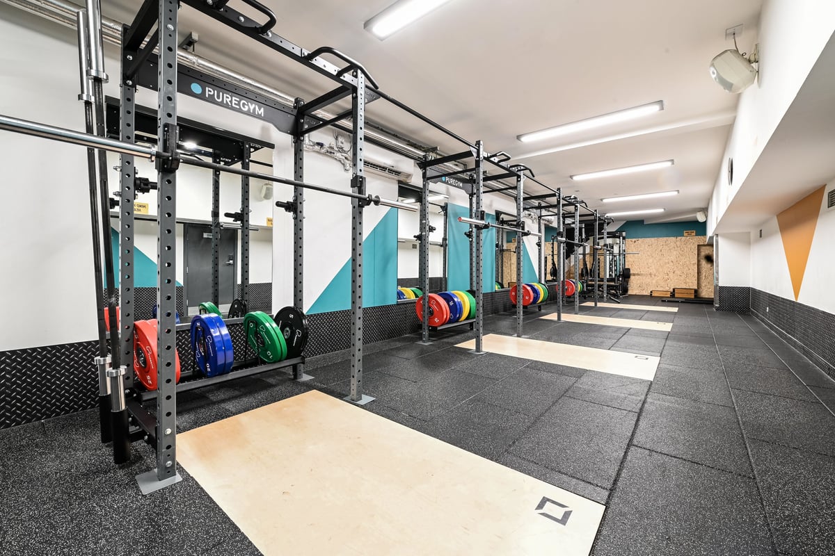 PureGym London Piccadilly: Strength racks, weight plates, rubberized flooring in a functional training space.