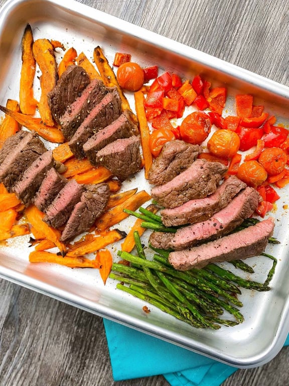 Sliced steak on a bed of vegetables