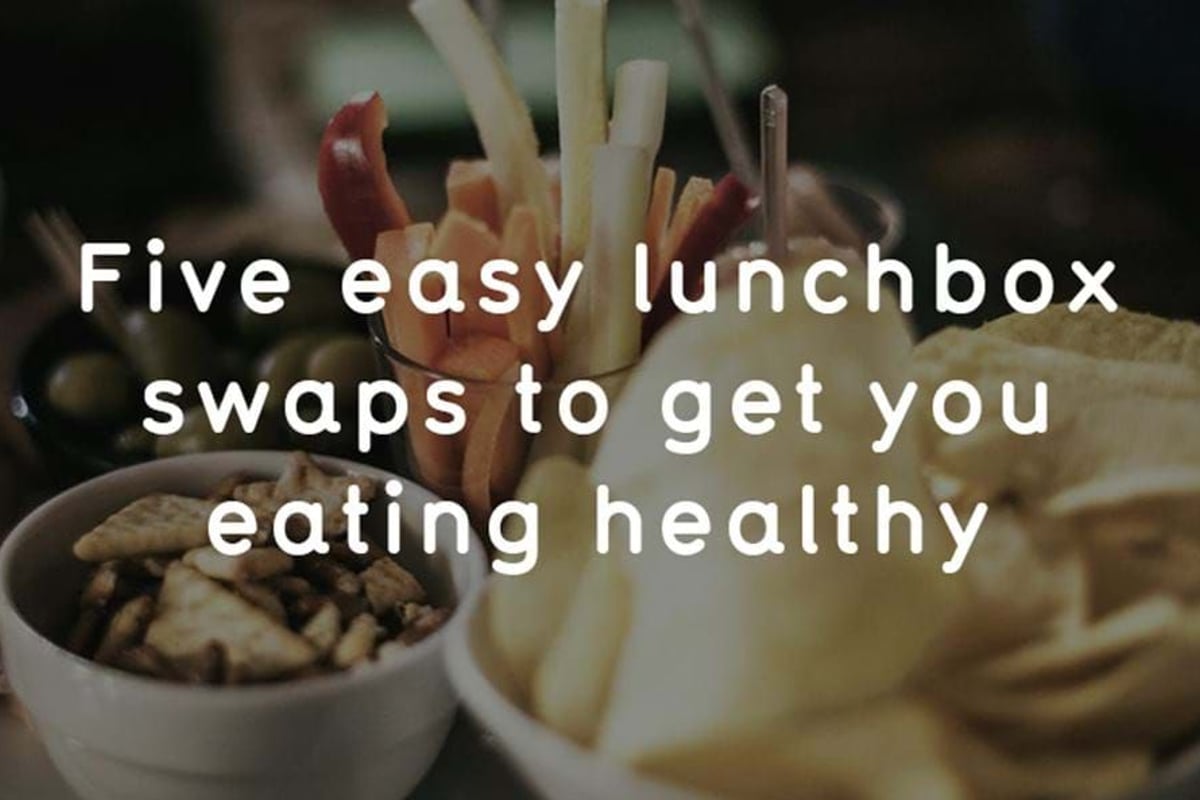 Bowls of nuts, vegetable sticks, and crisps on a dark surface