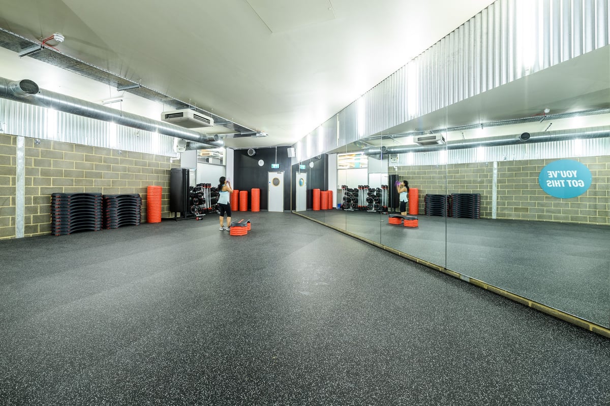 PureGym London Borough: Mirrored studio with weight plates, resistance machines, rubberized flooring.