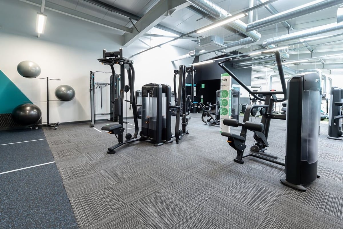 PureGym Colchester Retail Park: Weight machines, resistance bands, medicine balls, and rubberized flooring in a gym setting.