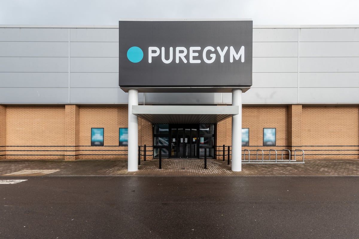 PureGym Port Talbot: Teal-accented gym exterior with entrance canopy and glass doors.