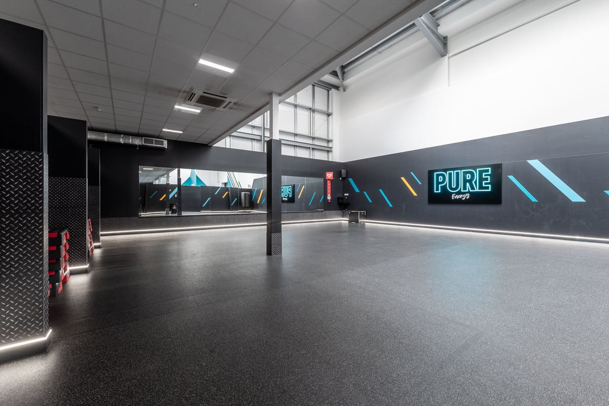 PureGym Coventry Warwickshire Shopping Park: Open gym studio space with mirrors along walls, rubberized flooring.