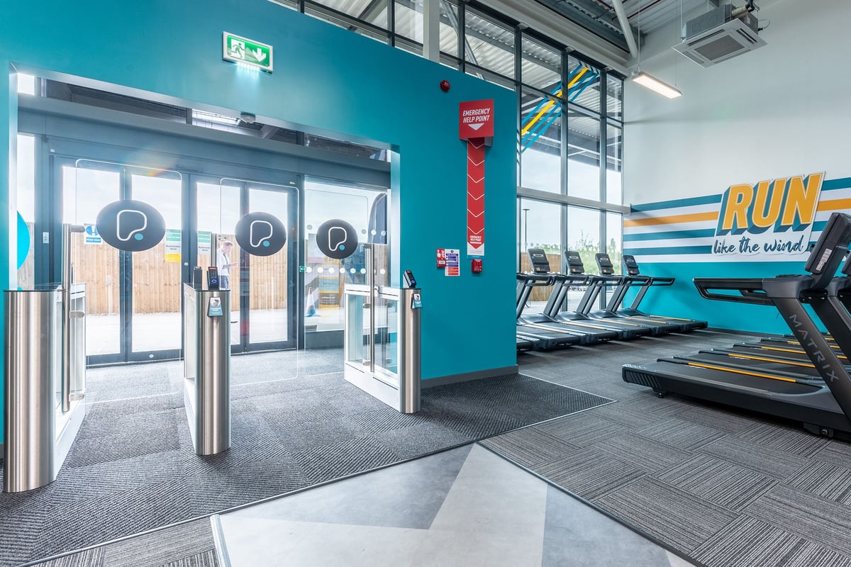 PureGym Nottingham Colwick: Treadmills, turnstiles, and "RUN like the wind" wall signage in a gym facility.