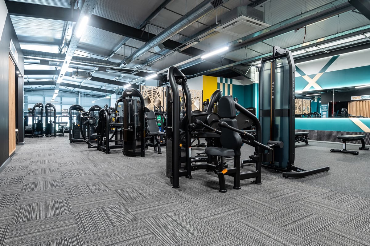 PureGym Glasgow Rutherglen: Resistance machines, benches, weight racks, and rubberized flooring in a modern gym setting.