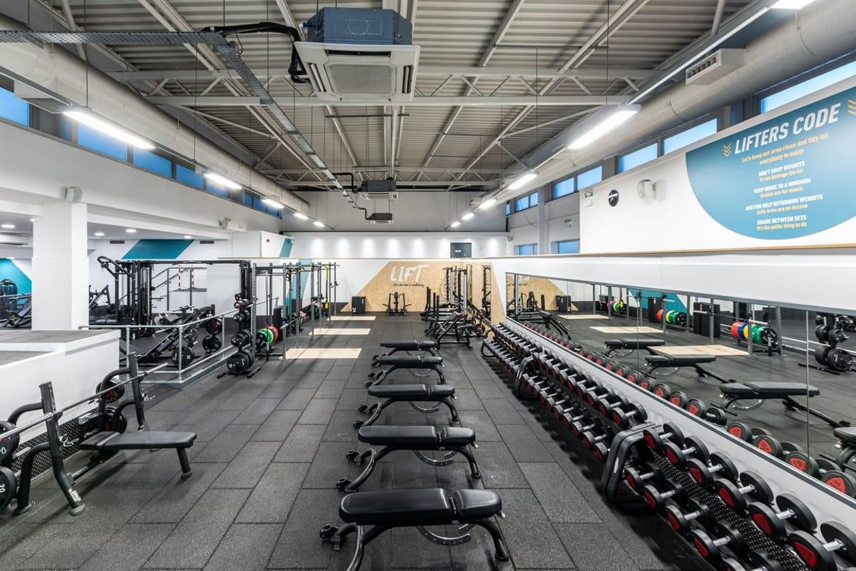 PureGym London Edgware: Rows of weight benches, dumbbell racks, and resistance machines in a large gym facility.