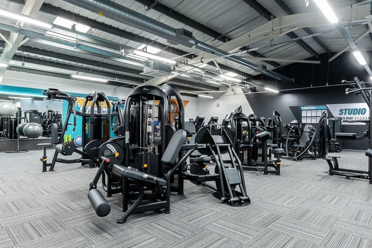 PureGym Boston: Strength training equipment including cable machines, benches, weight stacks, and mirrored studio space.