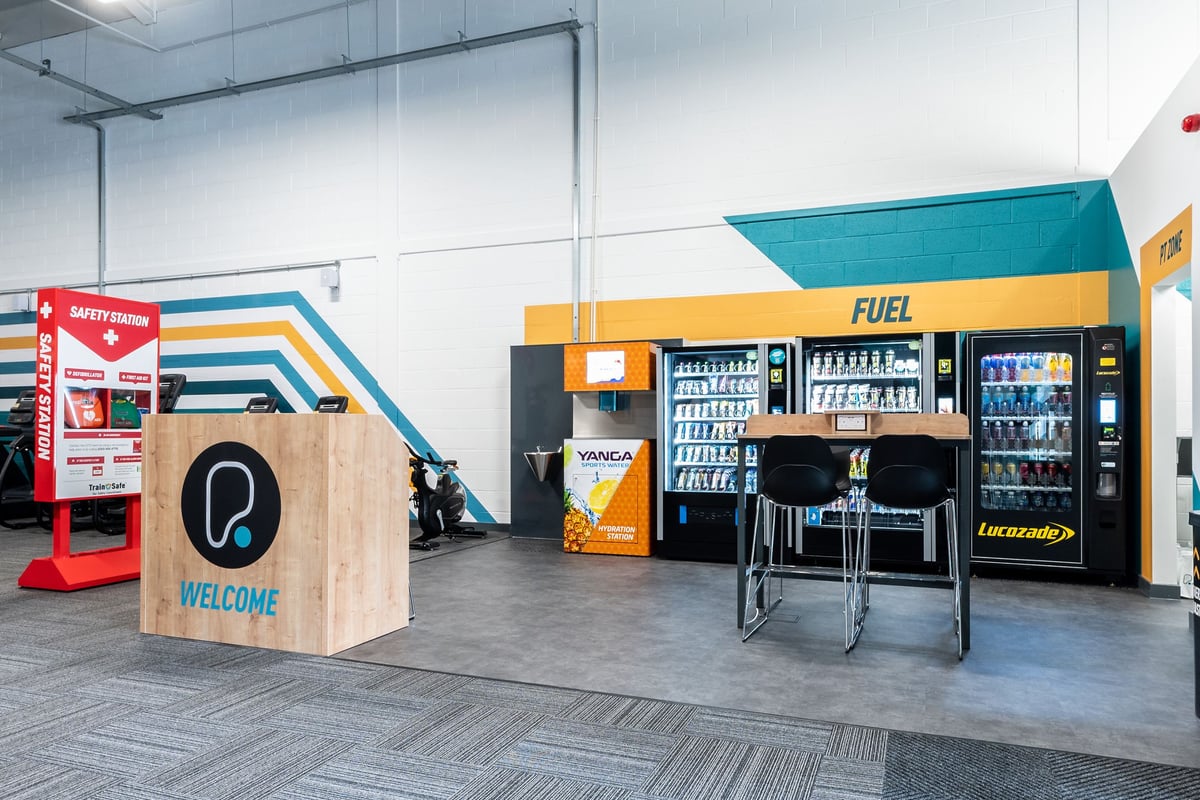 PureGym Byfleet: Vending machines, safety station, seating area and welcome kiosk.