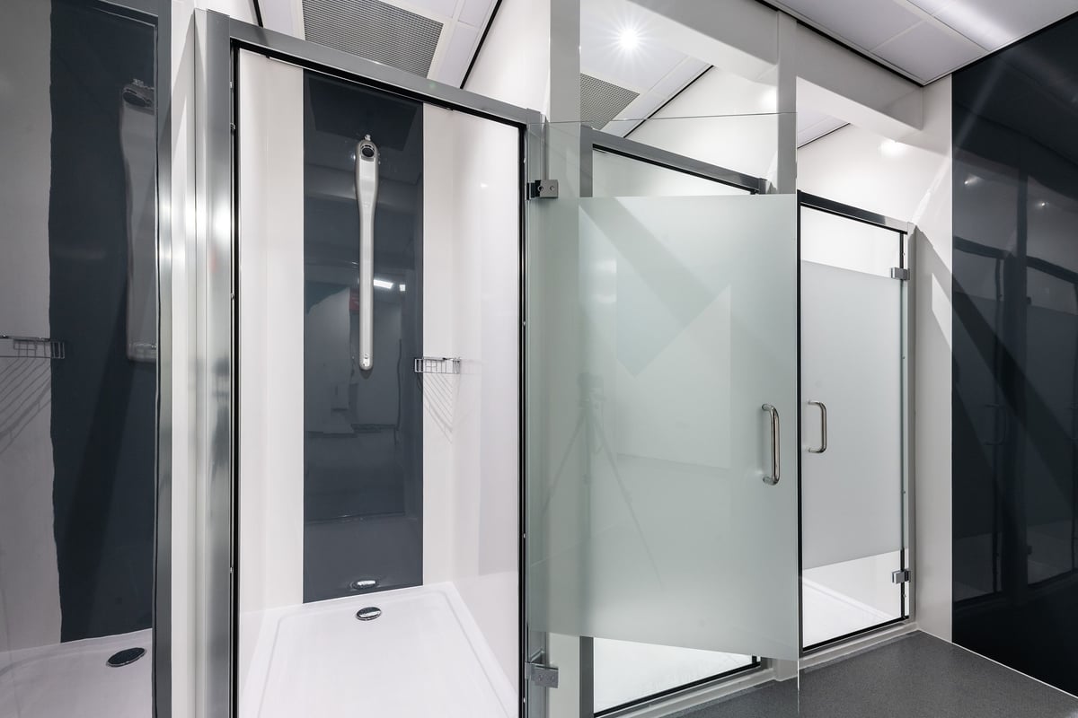 PureGym Blyth: Shower cubicles with frosted glass doors, tiled floors and walls.