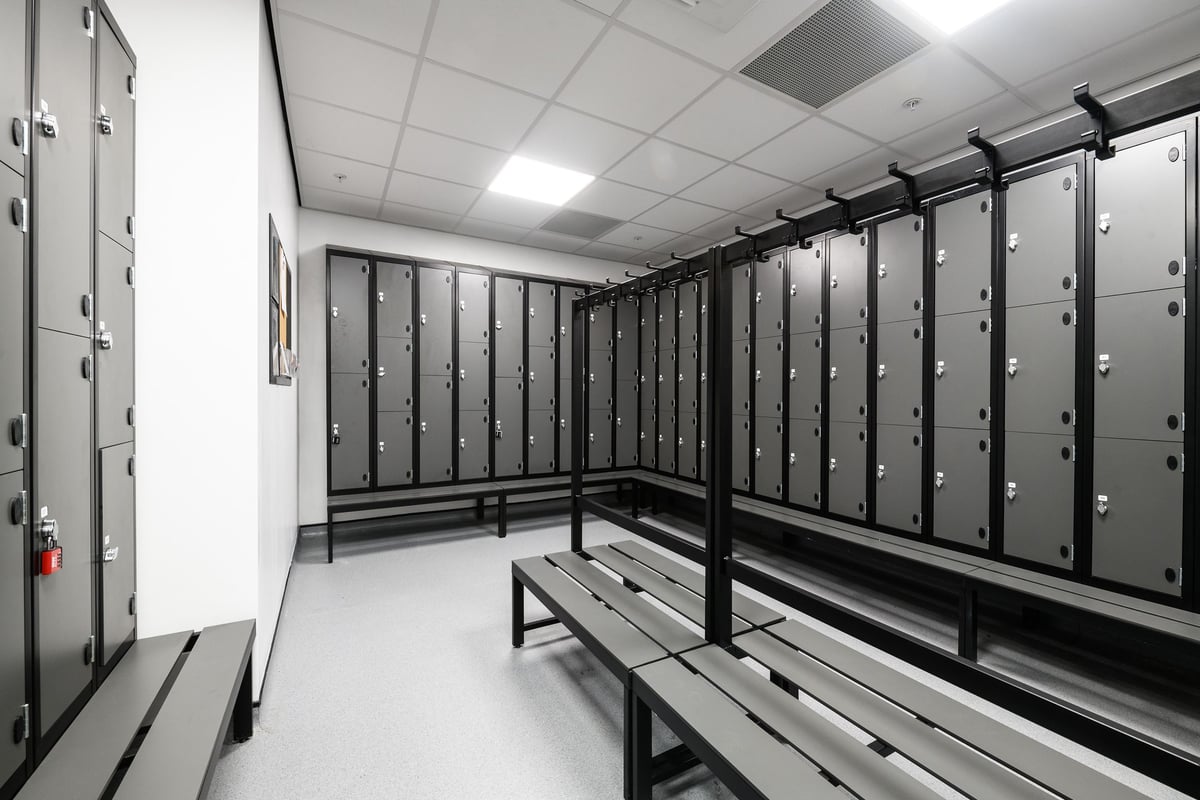 PureGym Cambridge Grafton Centre: Rows of lockers, benches in a changing room setting.