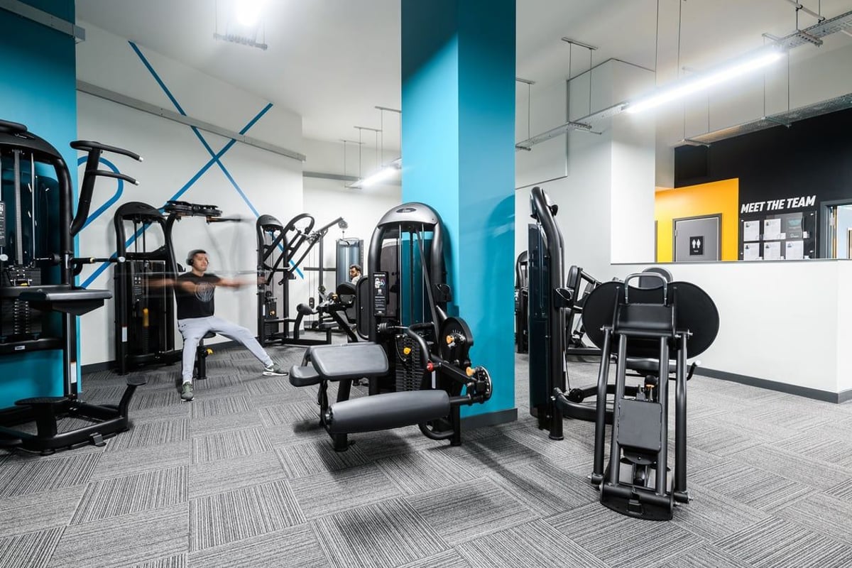 PureGym London Whitechapel: Multiple resistance machines, cable pulleys, benches, and weight racks in a modern gym space.