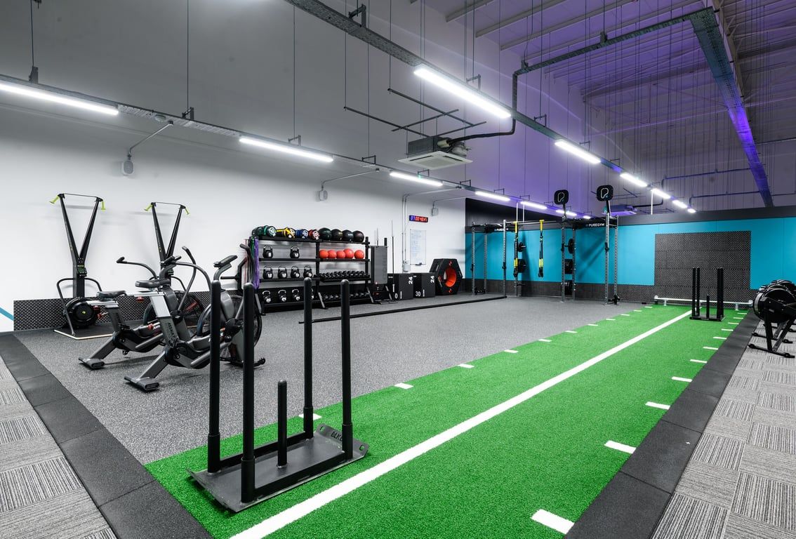 PureGym Nottingham Castle Marina: Resistance machines, suspension trainers, turf area, weights racks, industrial decor.