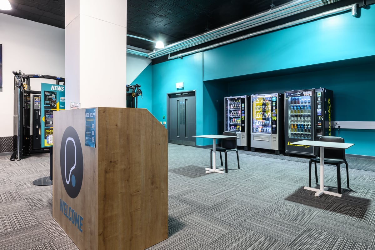 PureGym Birmingham Snow Hill Plaza hub area with vending machines and seating