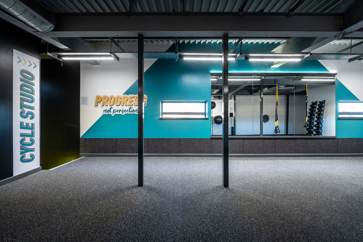PureGym Southampton Bitterne: Resistance machines, cables, weights, mirrored walls, and cushioned flooring in a gym studio.