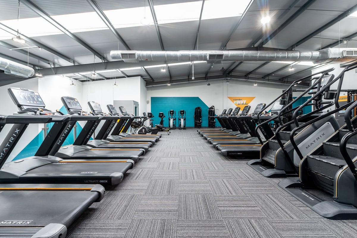 PureGym Coventry Warwickshire Shopping Park: Rows of treadmills, cycle machines and stair climbers in a modern gym facility.
